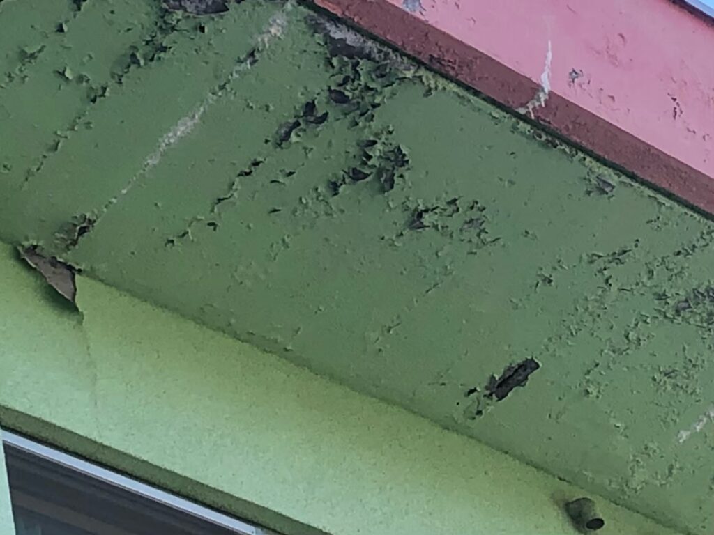 湿気や雨水の影響で軒天が腐食し、剥がれが発生している状態