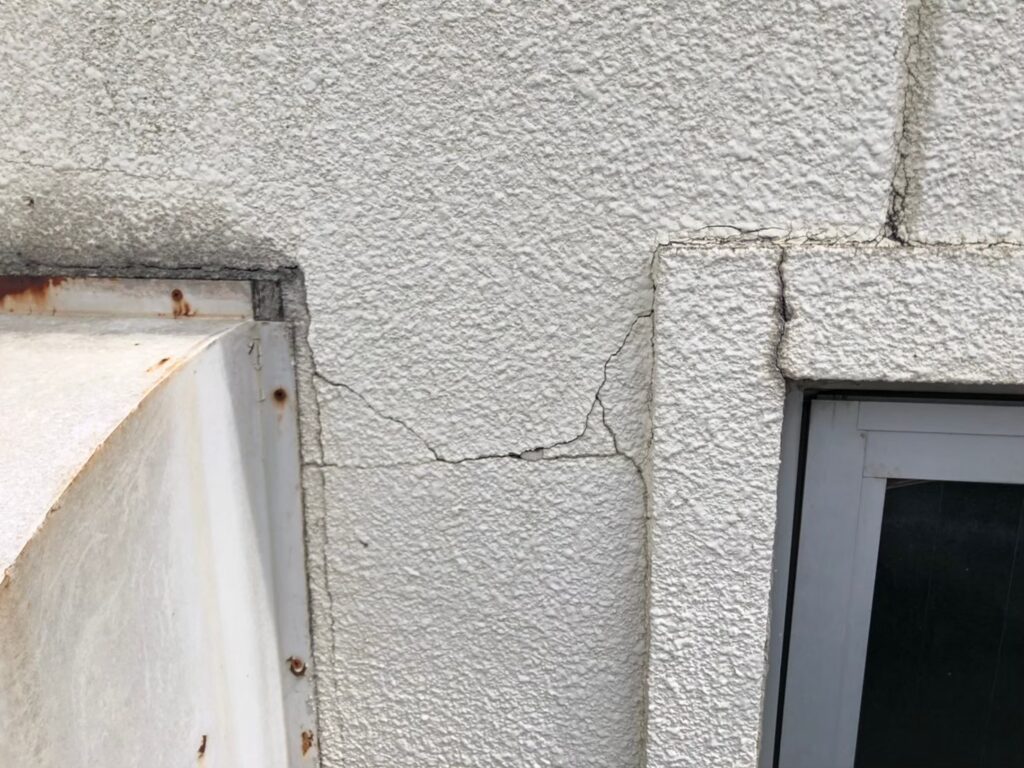 地震の影響により外壁表面がひび割れしている状態