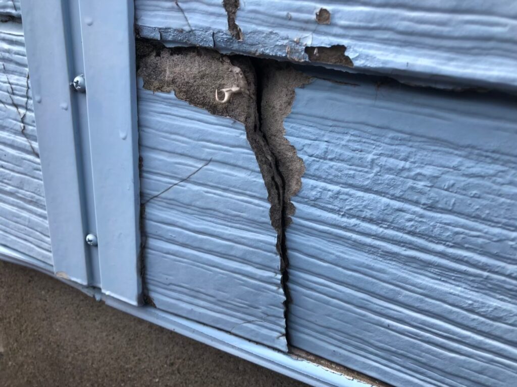 外壁の深いひび割れで建物内部が露出し始めている危険な状態