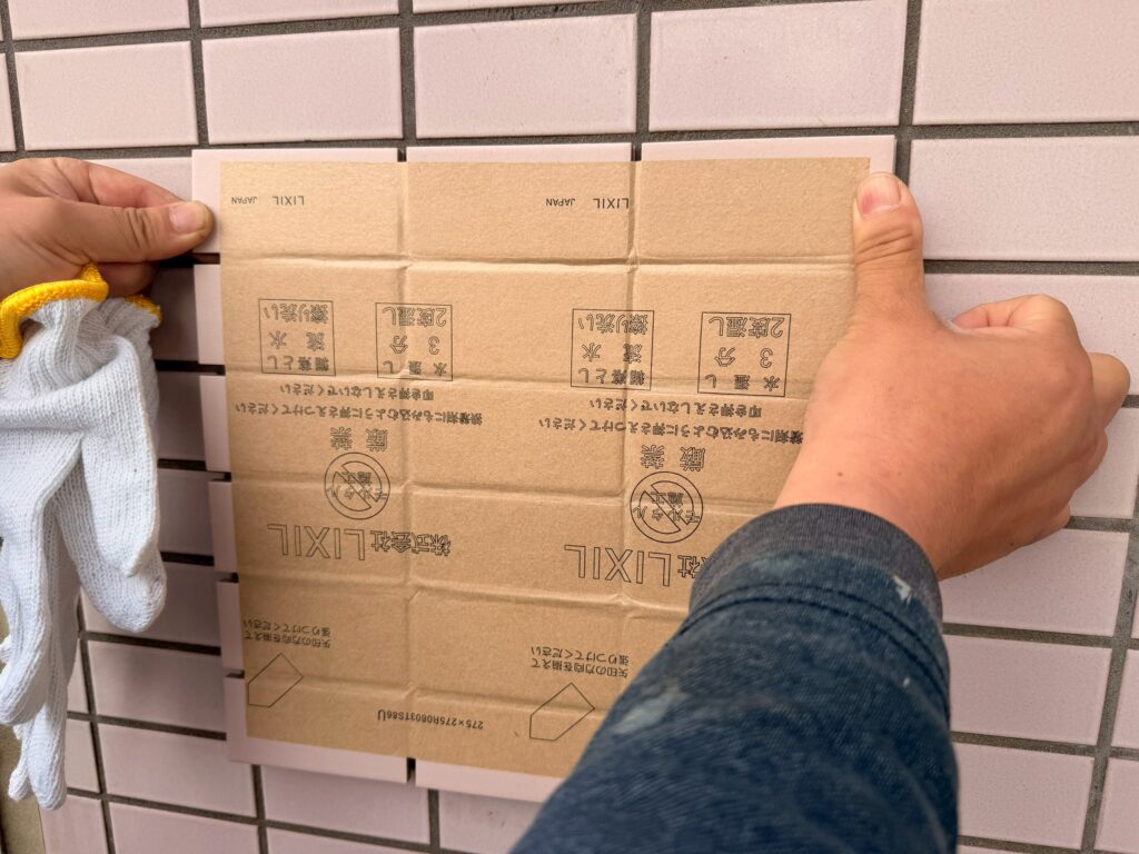 LIXIL製の外壁タイルを既存の外壁タイルに合わせ色合いを比較している写真